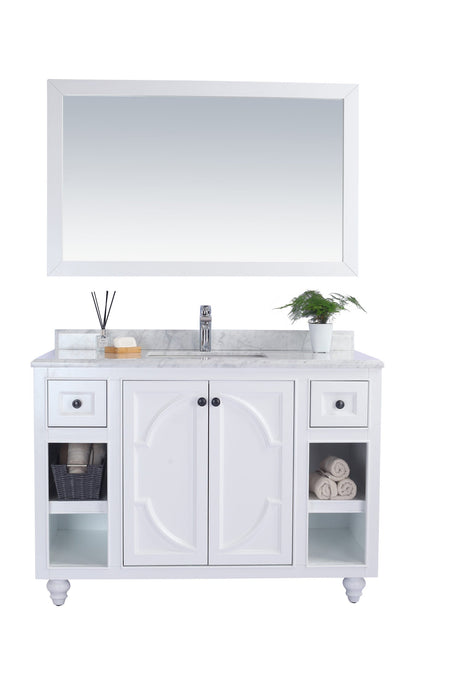 White bathroom vanity with marble countertop and mirror.