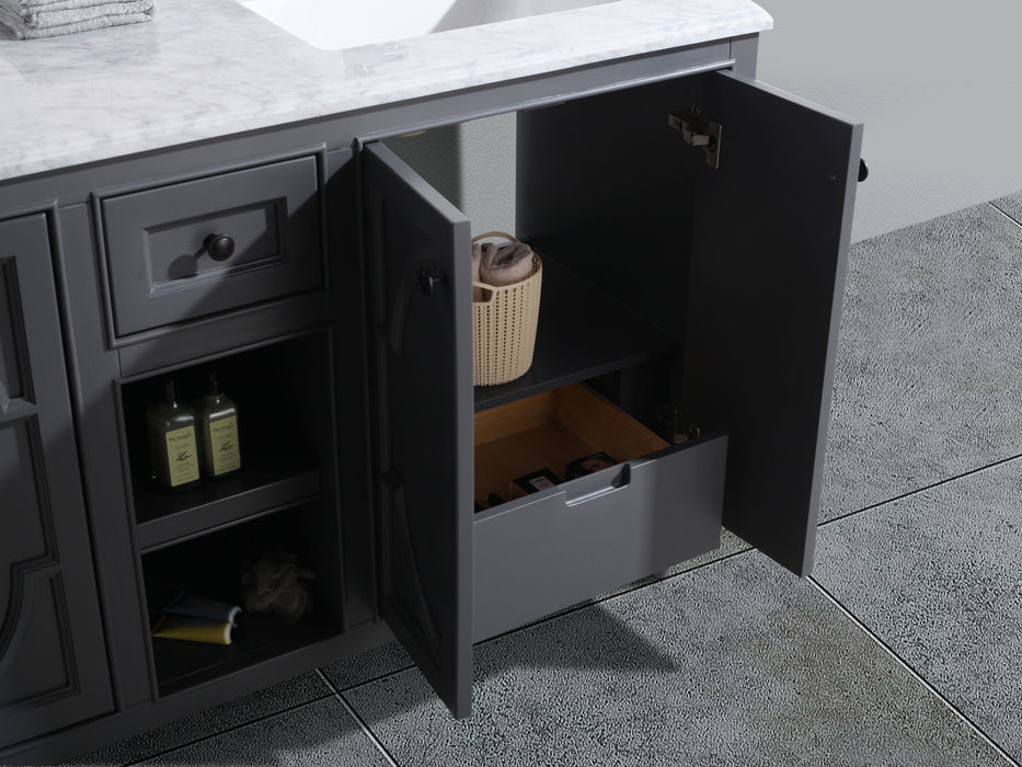 Gray vanity with open cabinet doors, revealing a shelf, drawer, toiletries, and a marble countertop.