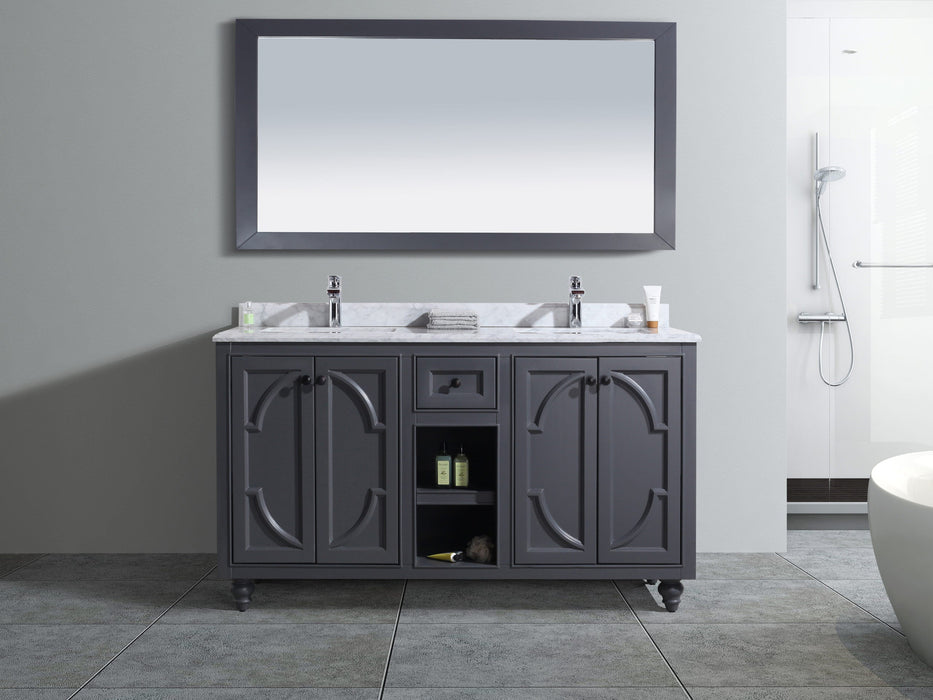 Gray bathroom vanity with marble countertop, double sinks, matching mirror, in a tiled bathroom.