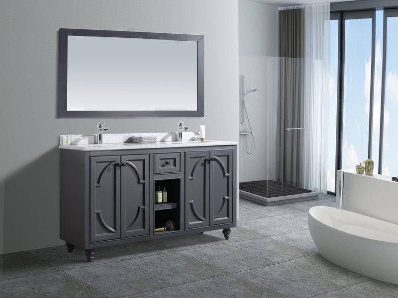 Gray vanity with a white marble countertop, a large mirror, and a freestanding white bathtub in a bathroom.