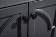 Close-up of gray cabinet doors with matte black knob pulls.