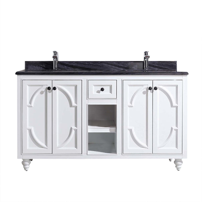 White vanity with black countertop and silver faucets.
