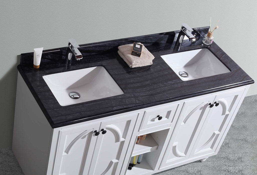 Double-sink vanity with black countertop and white cabinetry.