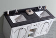 Double-sink vanity with black countertop and white cabinetry.
