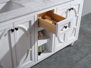 White vanity with marble countertop and open drawer.