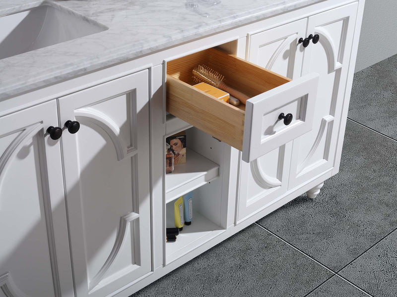 White vanity with marble countertop and open drawer.