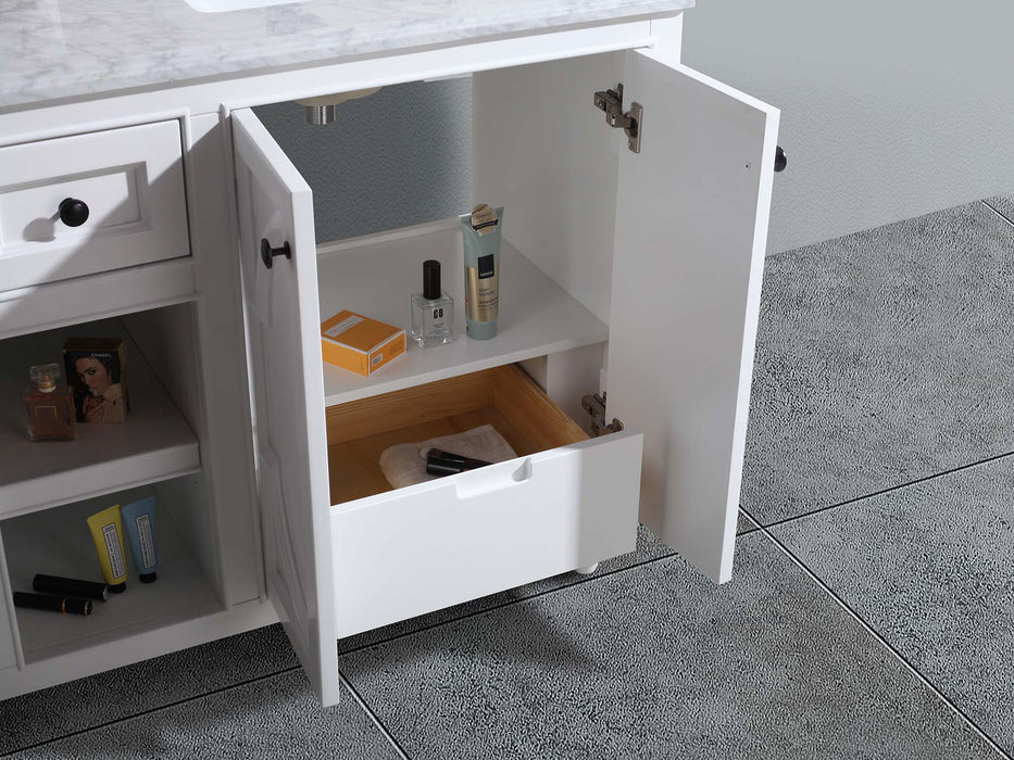 Open white bathroom vanity with drawer, shelf, and toiletries.
