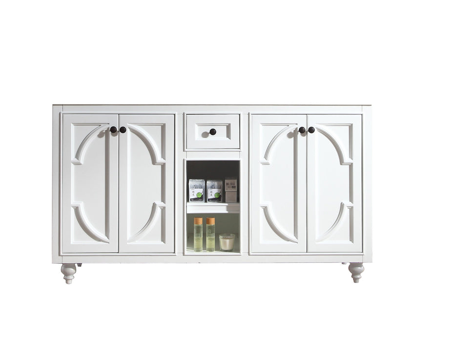 White bathroom vanity with dark knobs and decorative molding.