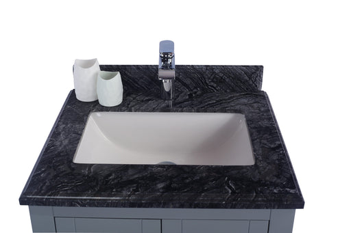 Bathroom vanity with black marble countertop, white sink, and silver faucet.