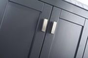 Close-up of gray cabinet doors with silver handles.