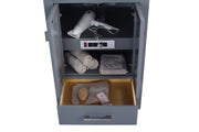 Gray vanity with open cabinet doors and drawer, showcasing a hair dryer, towels, hairbrush, and perfume.