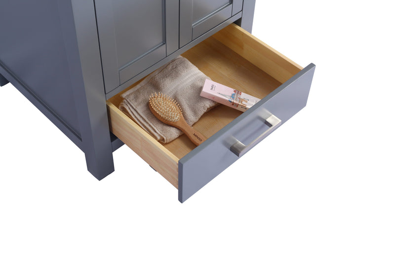 Gray vanity with open drawer containing towel, hairbrush, and perfume.