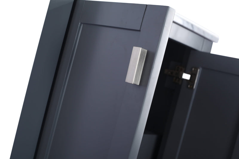 Close-up of a gray bathroom cabinet with a silver handle and open doors.