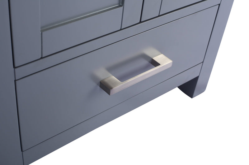 Gray bathroom vanity with a rectangular silver handle.
