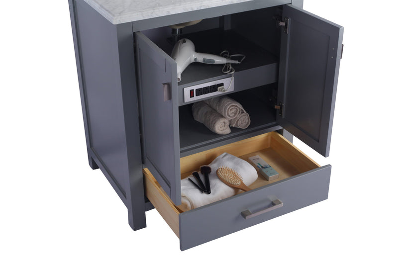 Open gray bathroom vanity with white countertop, shelves, and drawer containing toiletries.