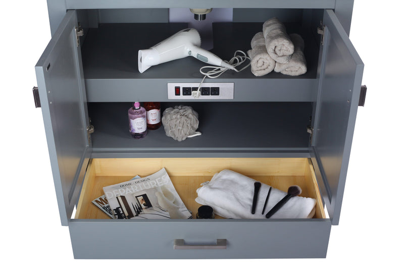Open grey vanity cabinet with outlets.