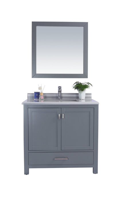 Gray vanity with mirror, countertop, sink, faucet, and potted plant.