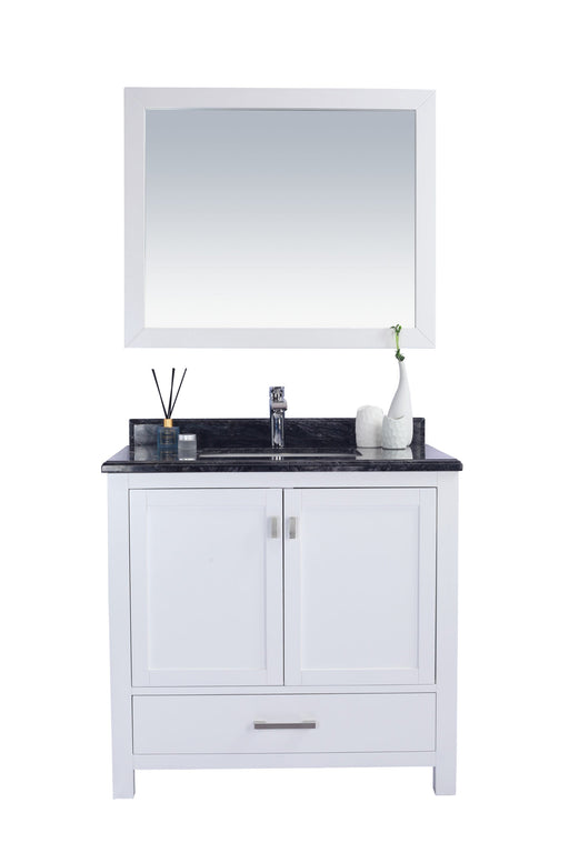 White vanity with black marble top and white mirror.