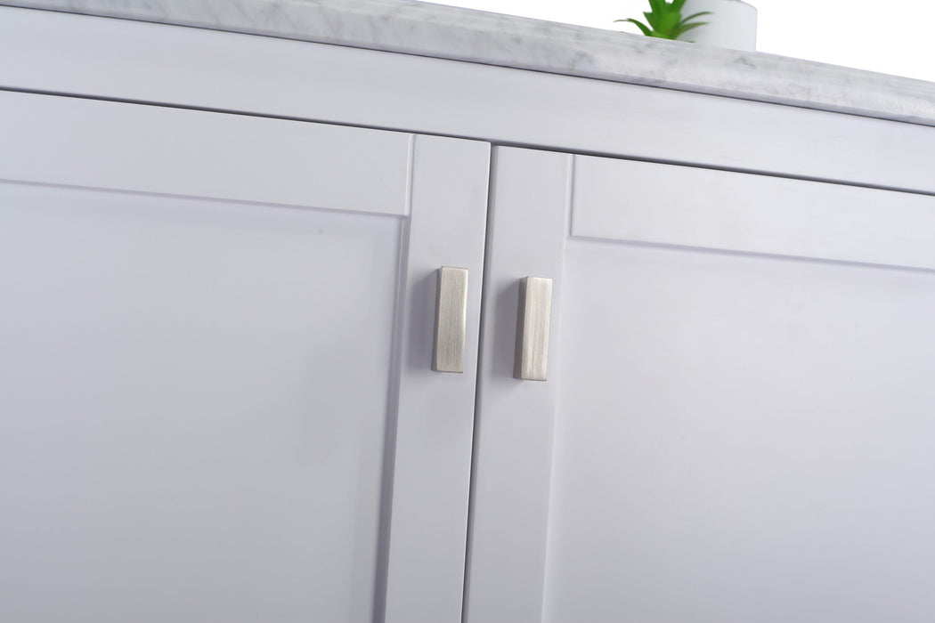 Close-up of a gray cabinet with brushed metal pulls and a white countertop.
