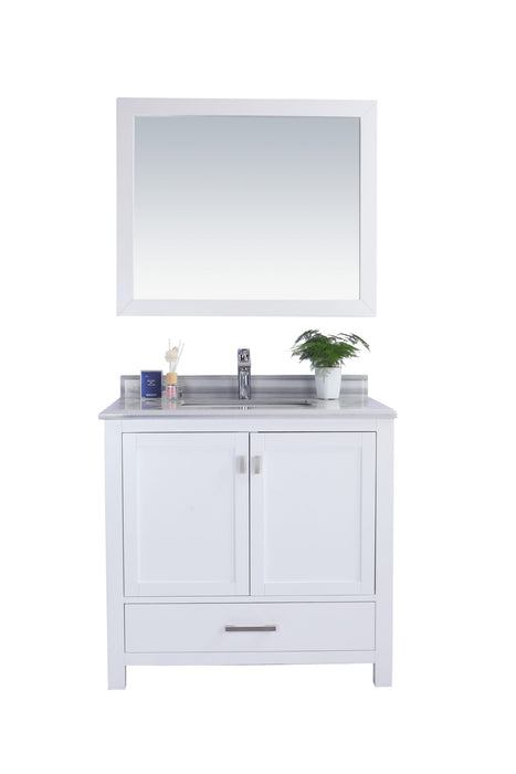 White bathroom vanity with mirror, marble countertop, and decorative items.

