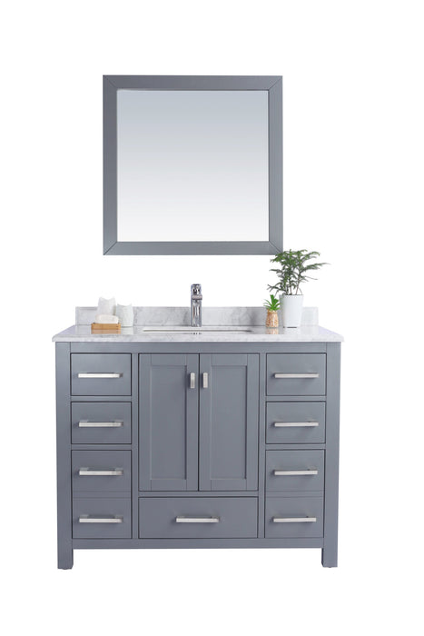 Gray bathroom vanity with drawers and a mirror.