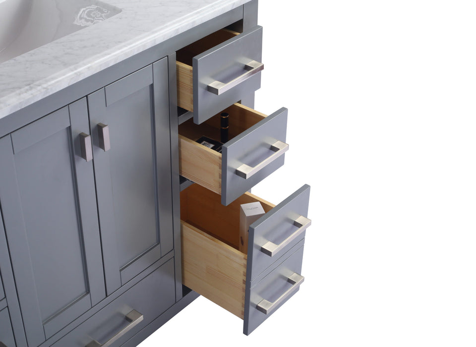 Gray vanity with open drawers, marble countertop.