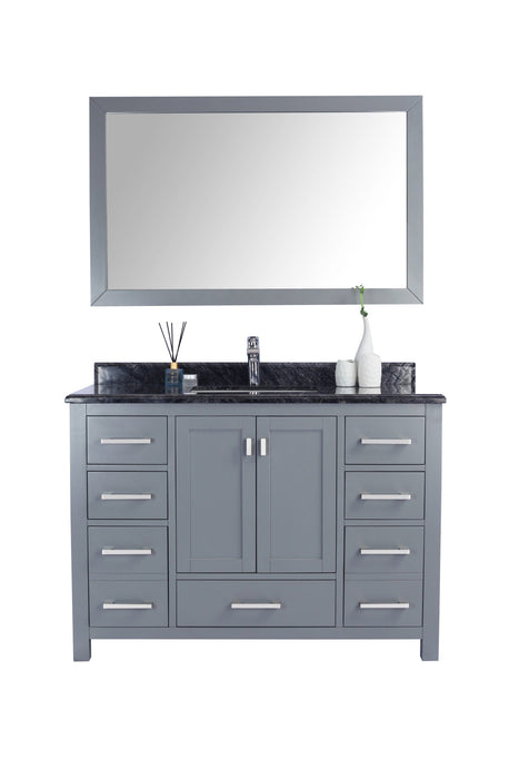 Gray vanity with a dark countertop, silver hardware, and a matching mirror.