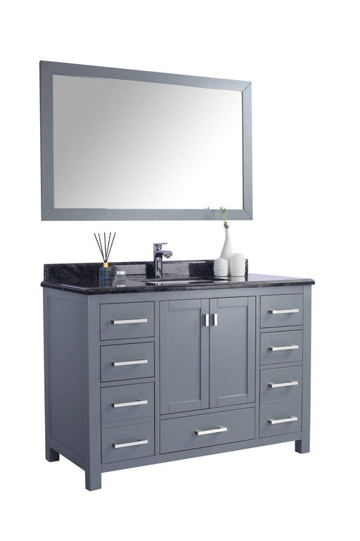 A gray bathroom vanity with a black countertop and a matching mirror.