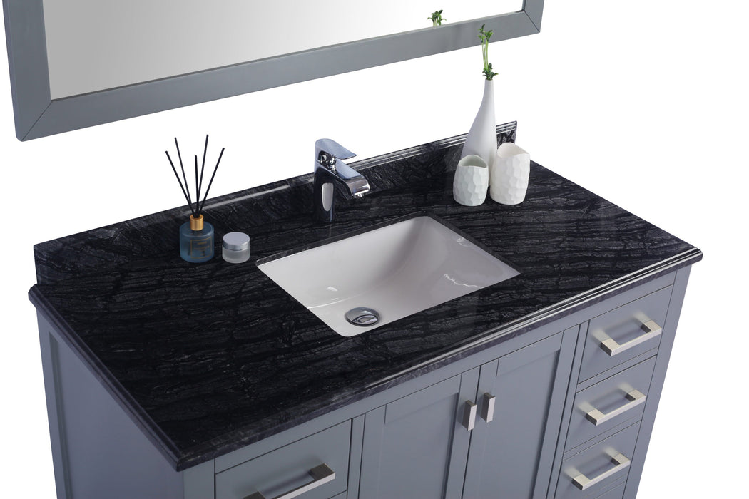 Gray vanity with black granite countertop and white sink, chrome faucet.