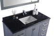 Gray vanity with black granite countertop and white sink, chrome faucet.