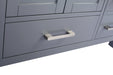 Close-up of gray cabinet doors and drawers with brushed metal handles.
