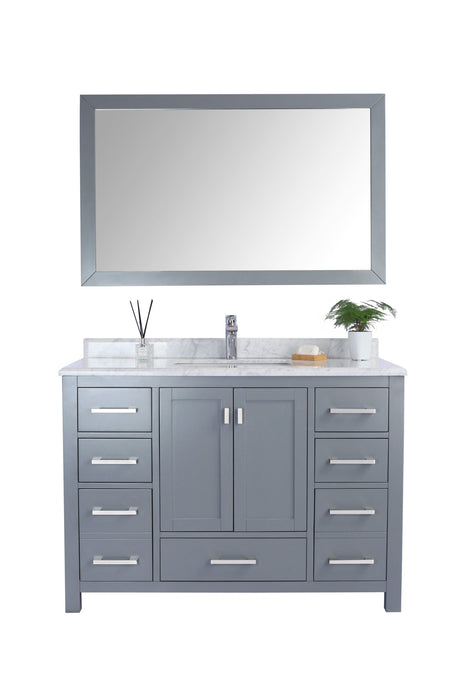 Gray vanity cabinet with white marble countertop and framed mirror.