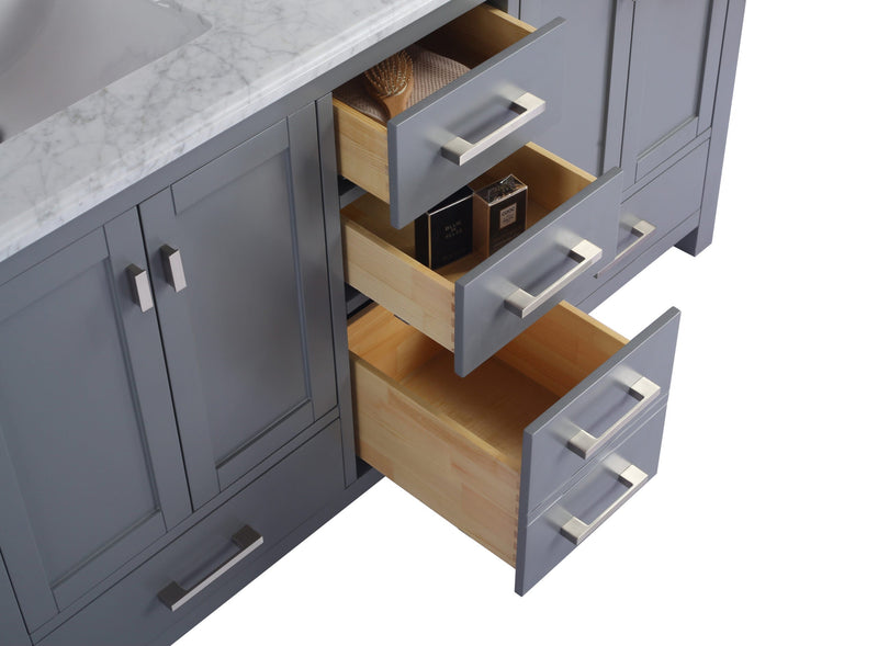 Gray bathroom vanity with open drawers revealing wooden interior.