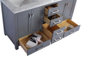 Gray bathroom vanity with marble countertop and open drawers.