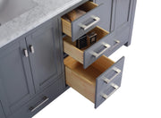 Gray bathroom vanity with open drawers, white marble top, silver hardware.