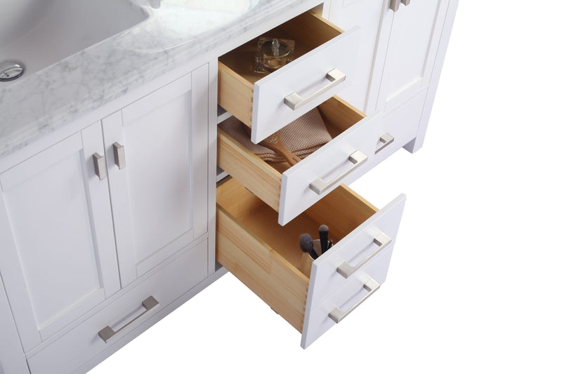 White vanity with marble top and open wooden drawers.