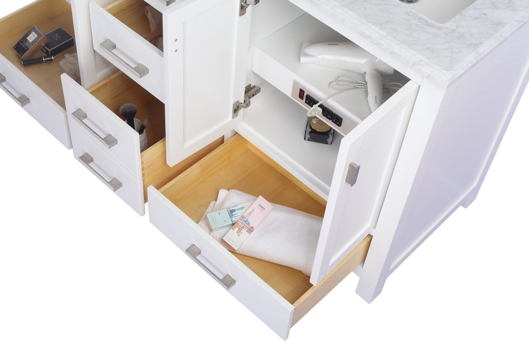 White bathroom vanity with open drawers and doors.