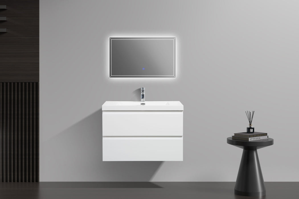 White floating bathroom vanity with illuminated mirror and side table.