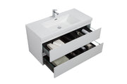 White bathroom vanity with open drawers filled with towels and toiletries.