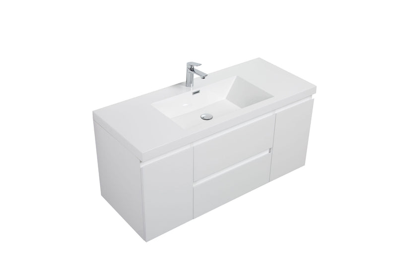 A white bathroom sink cabinet with a chrome faucet.