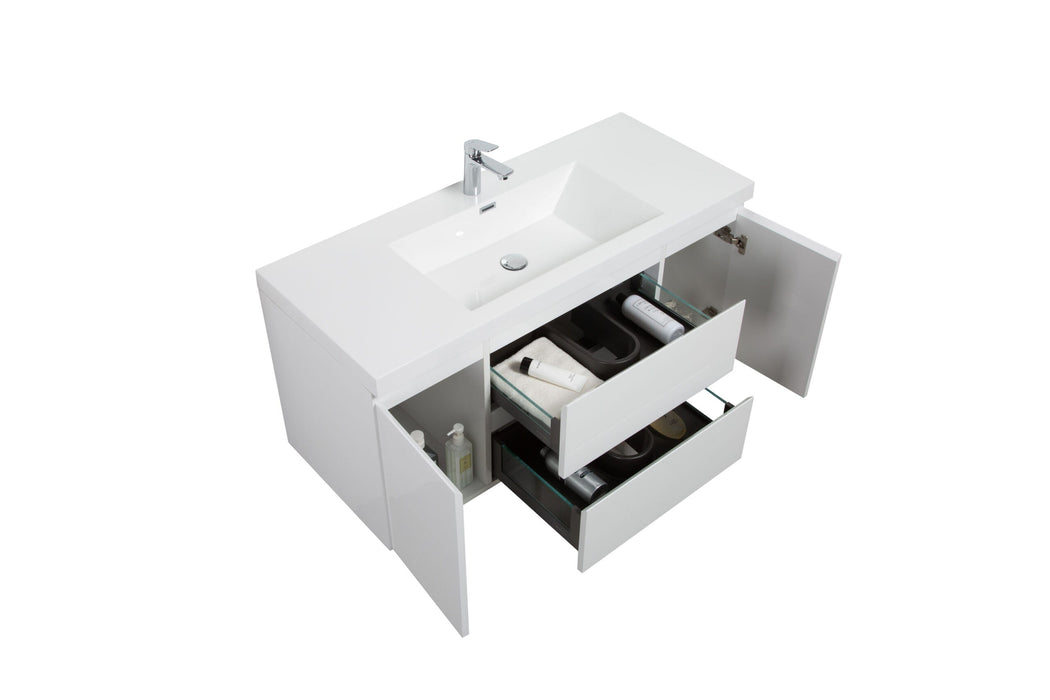 White bathroom vanity with open drawers and doors.