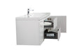 White bathroom vanity with drawers and faucet.