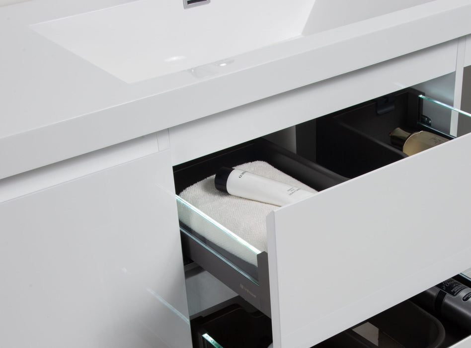White bathroom vanity with open drawers and toiletries.