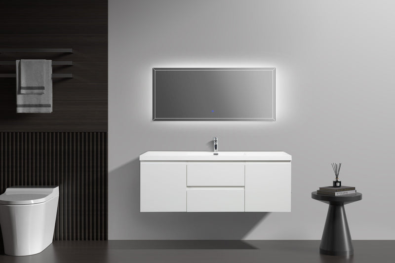 Bathroom with white vanity and toilet, dark wood accent wall, and illuminated mirror.