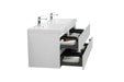 White bathroom vanity with two open drawers.