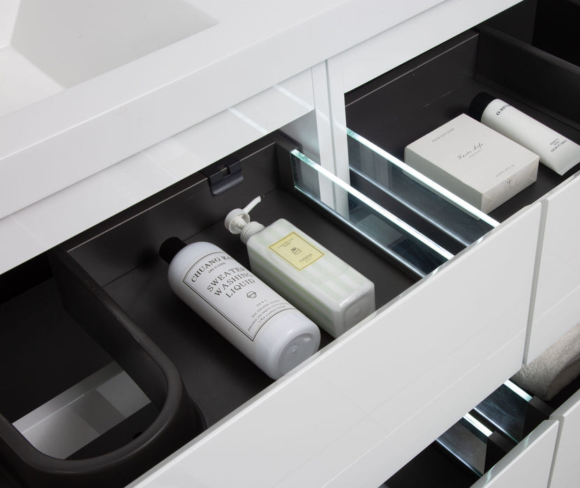 Open bathroom drawer with various personal care items.