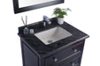 Bathroom vanity with black marble countertop, white sink, chrome faucet, potted plant, and cosmetic accessories.