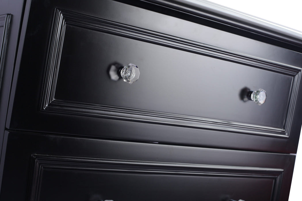 Close up of a black dresser with crystal knobs.