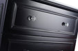 Close up of a black dresser with crystal knobs.