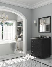 A luxurious bathroom featuring a freestanding tub, dark vanity, and marble floors with a patterned border.